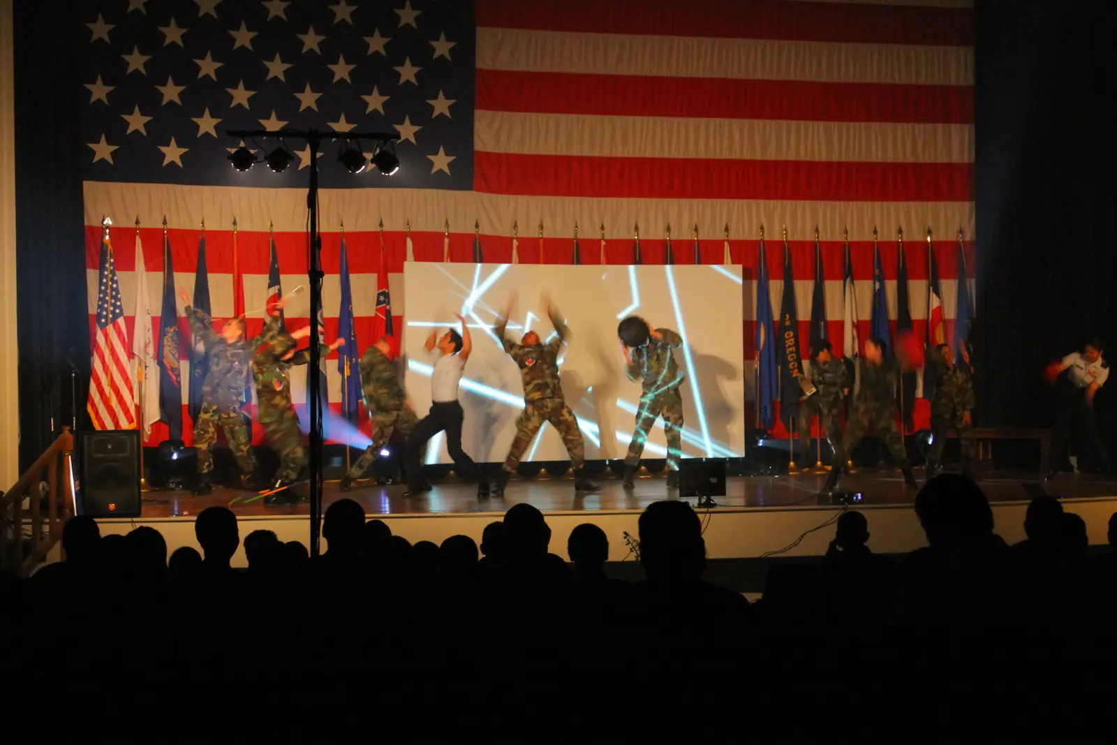 Stage presentation with an American flag backdrop