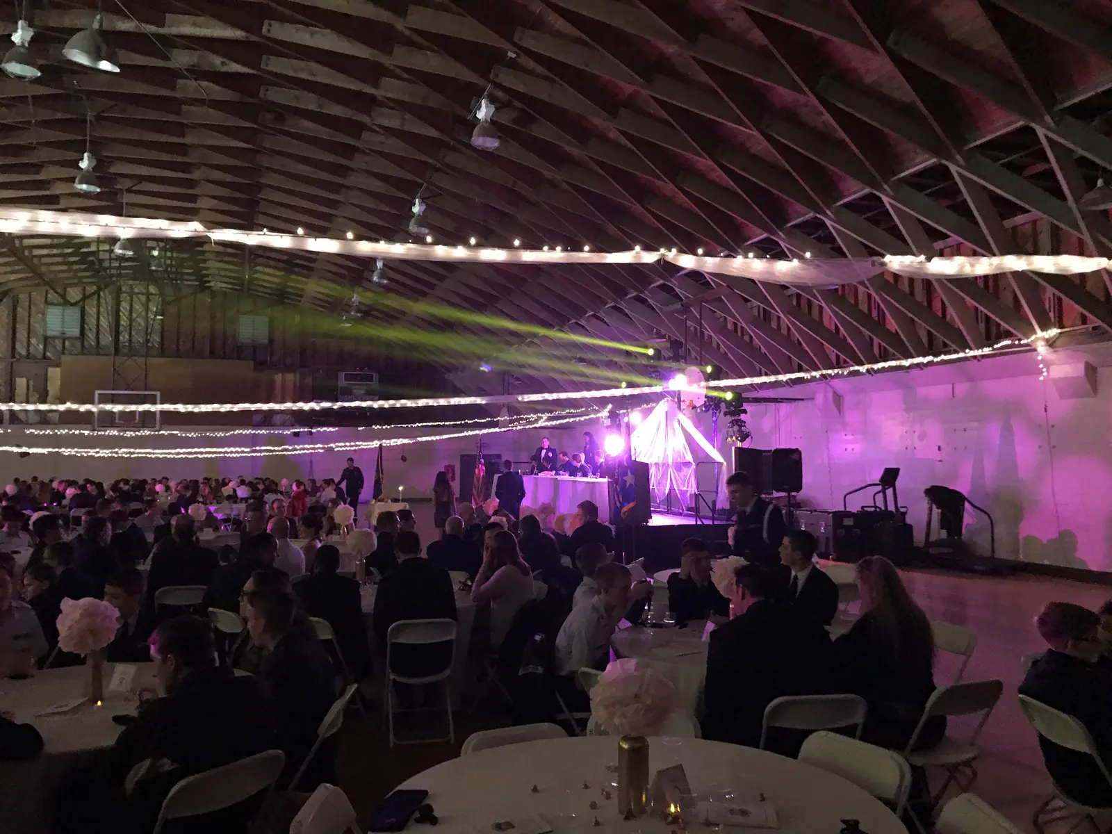 Large banquet event under stage lighting