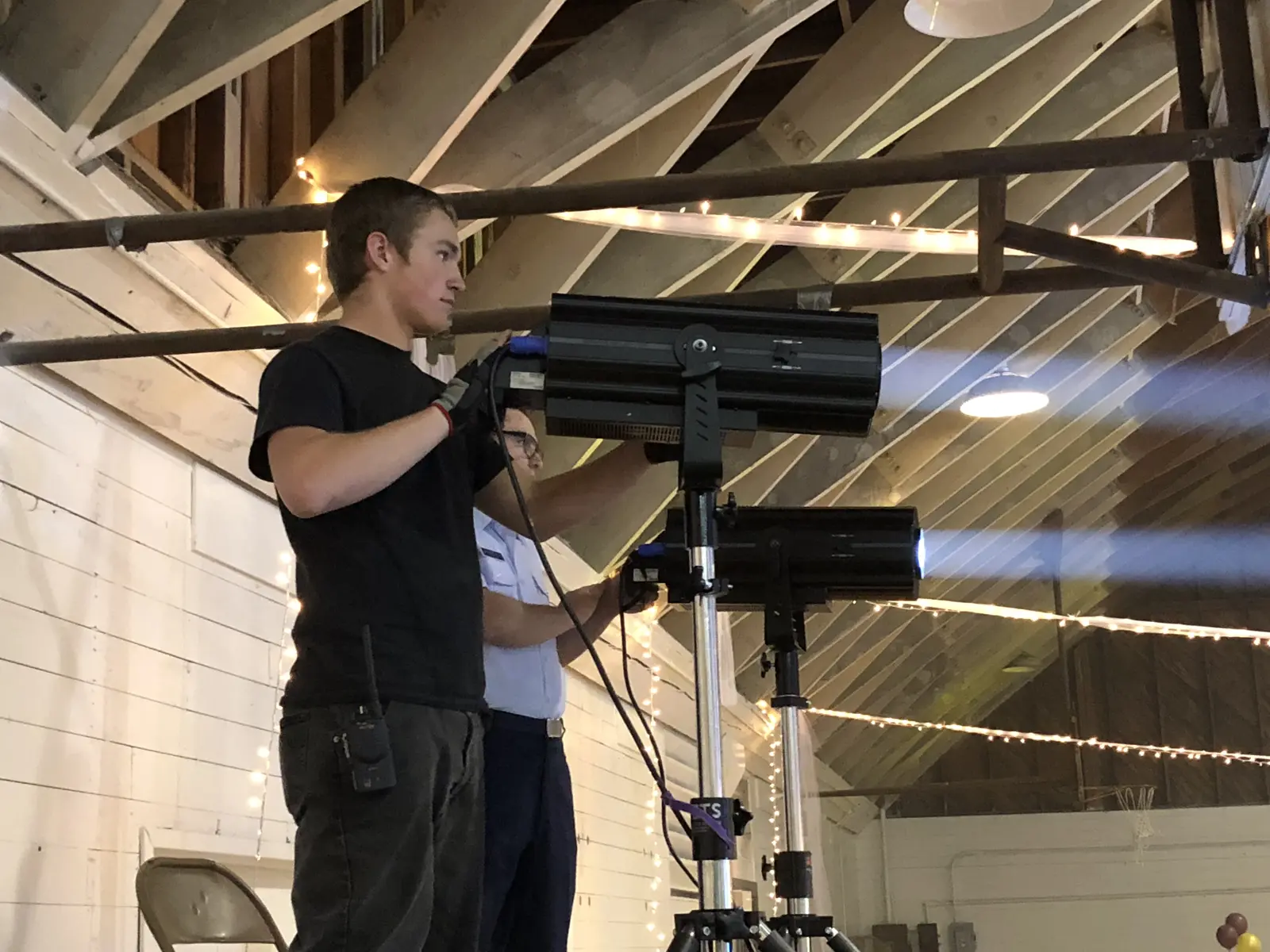 Technician positioning a stage-lighting fixture