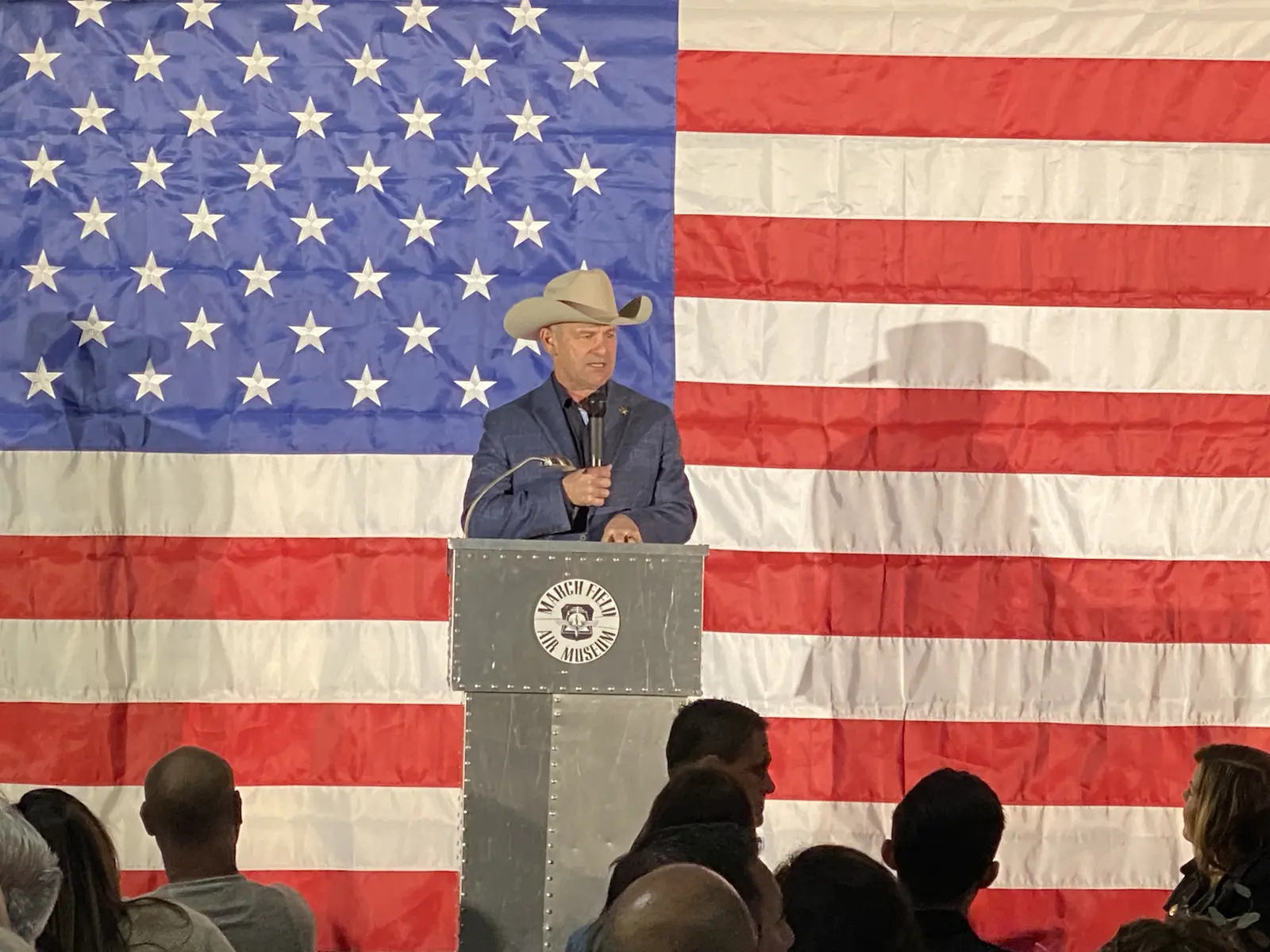 Speaker presenting in front of an American flag