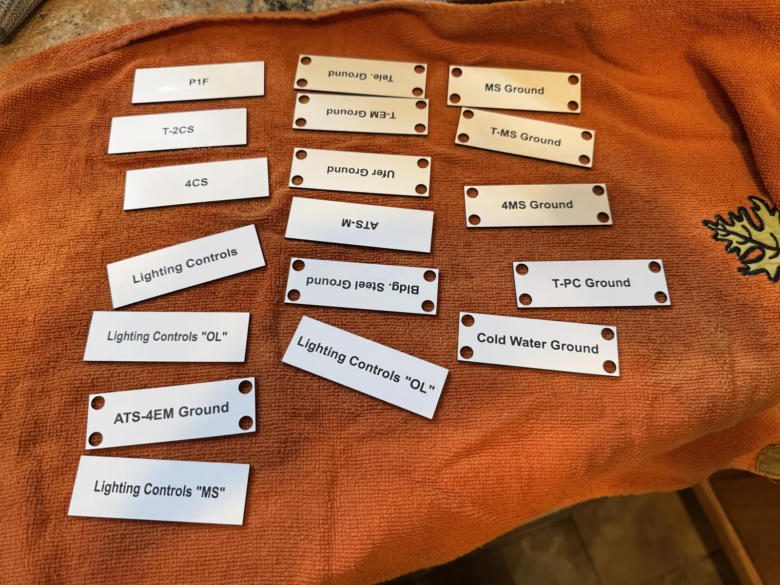 Assortment of engraved equipment tags
