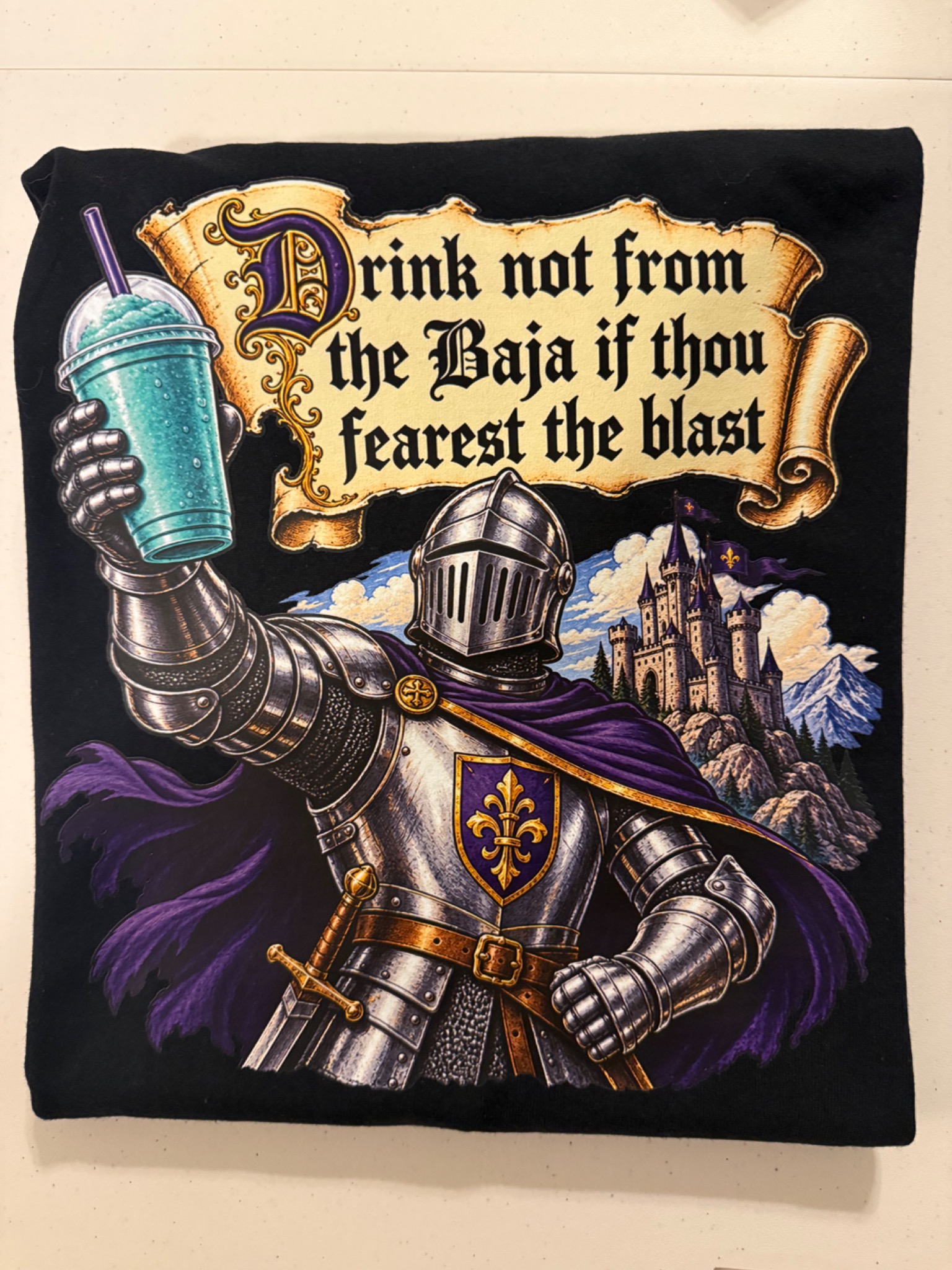 Black shirt with a knight holding a frozen drink and humorous lettering